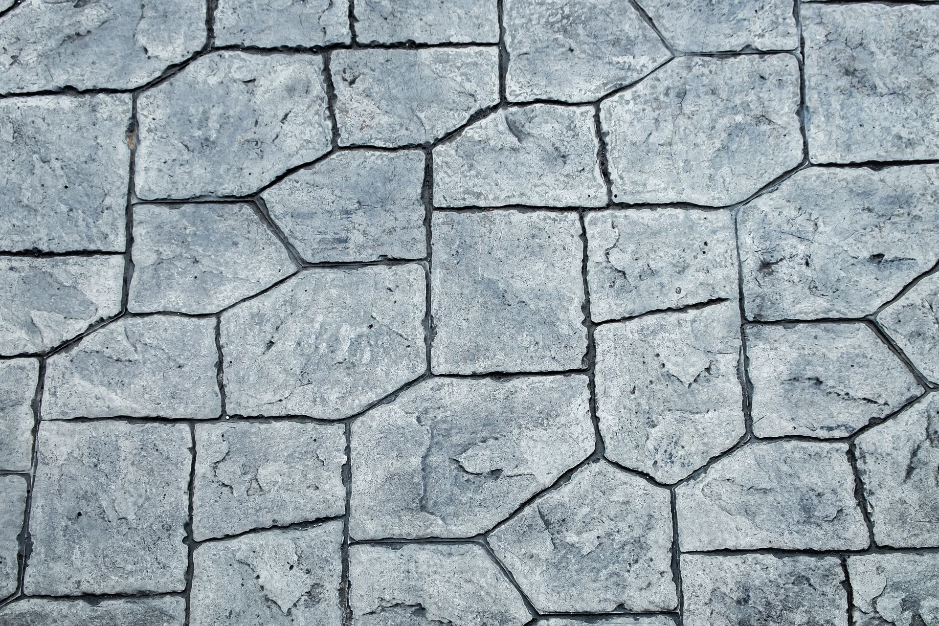 A close up of a gray stone floor with a geometric pattern.