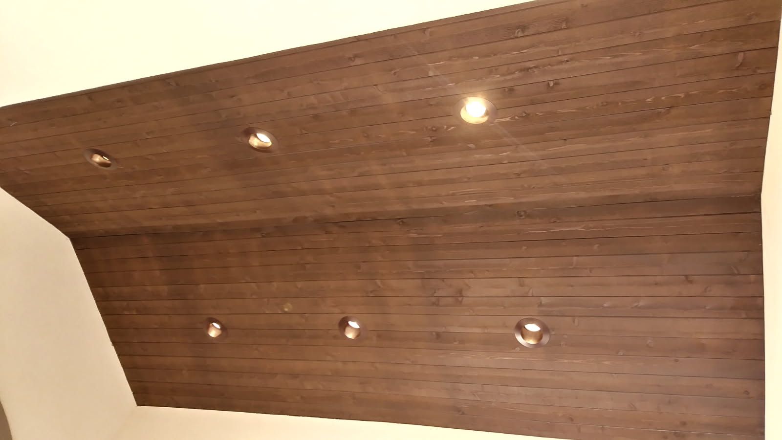 Wooden ceiling with recessed lights.