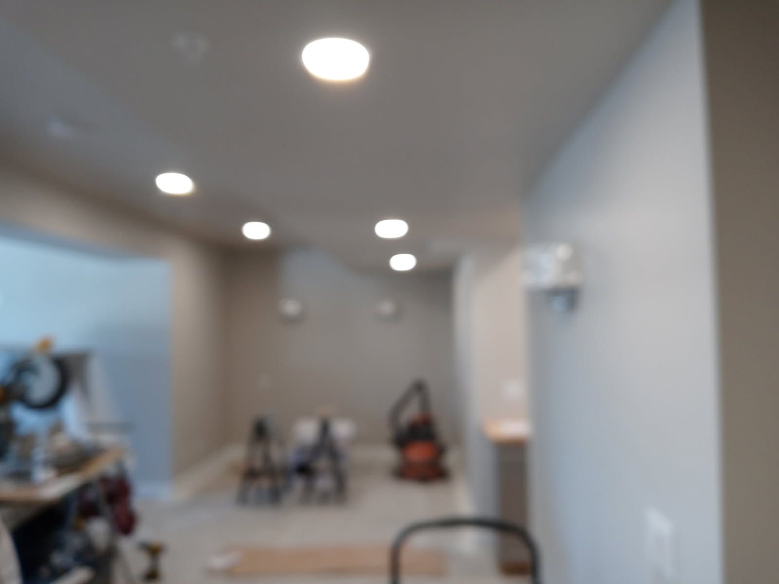 Interior room with recessed ceiling lights and construction materials.