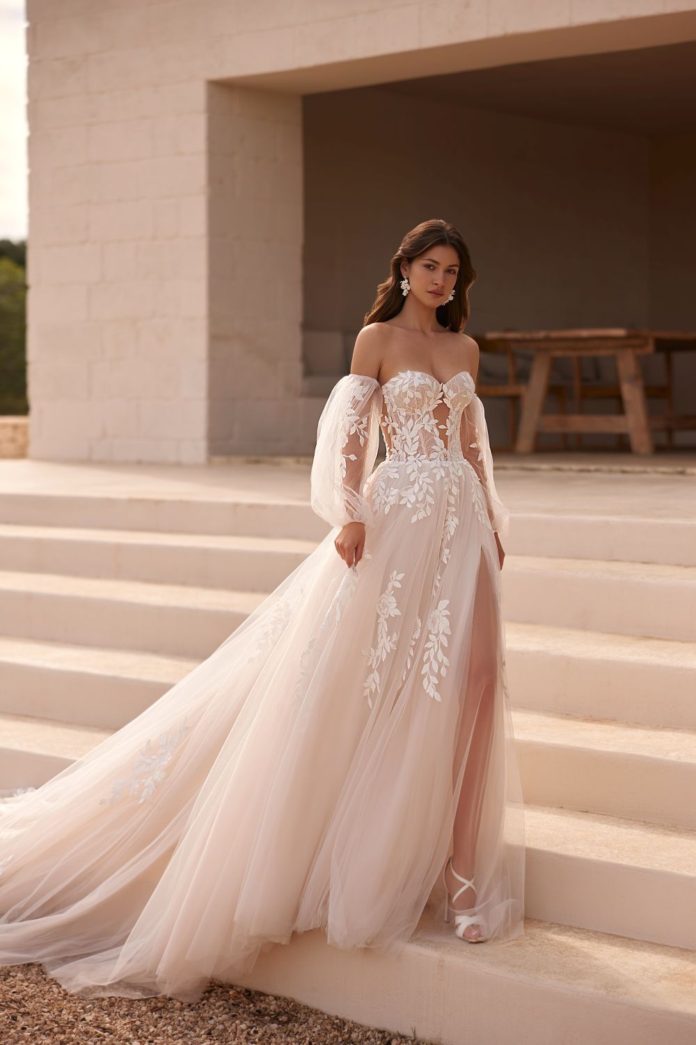 Eine Frau in einem Brautkleid steht auf einer Treppe.