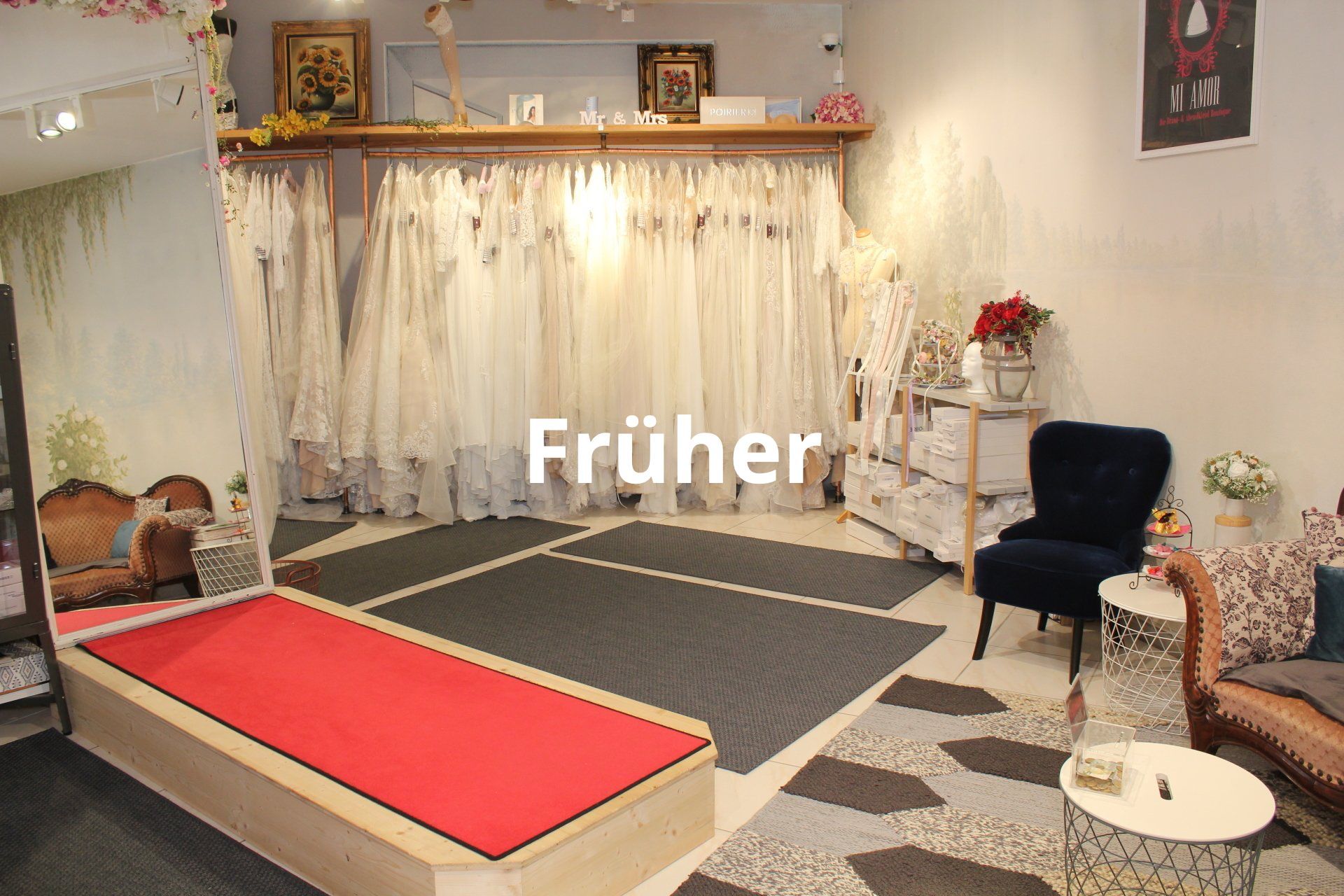 Ein Raum mit vielen ausgestellten Kleidern und einem roten Teppich.