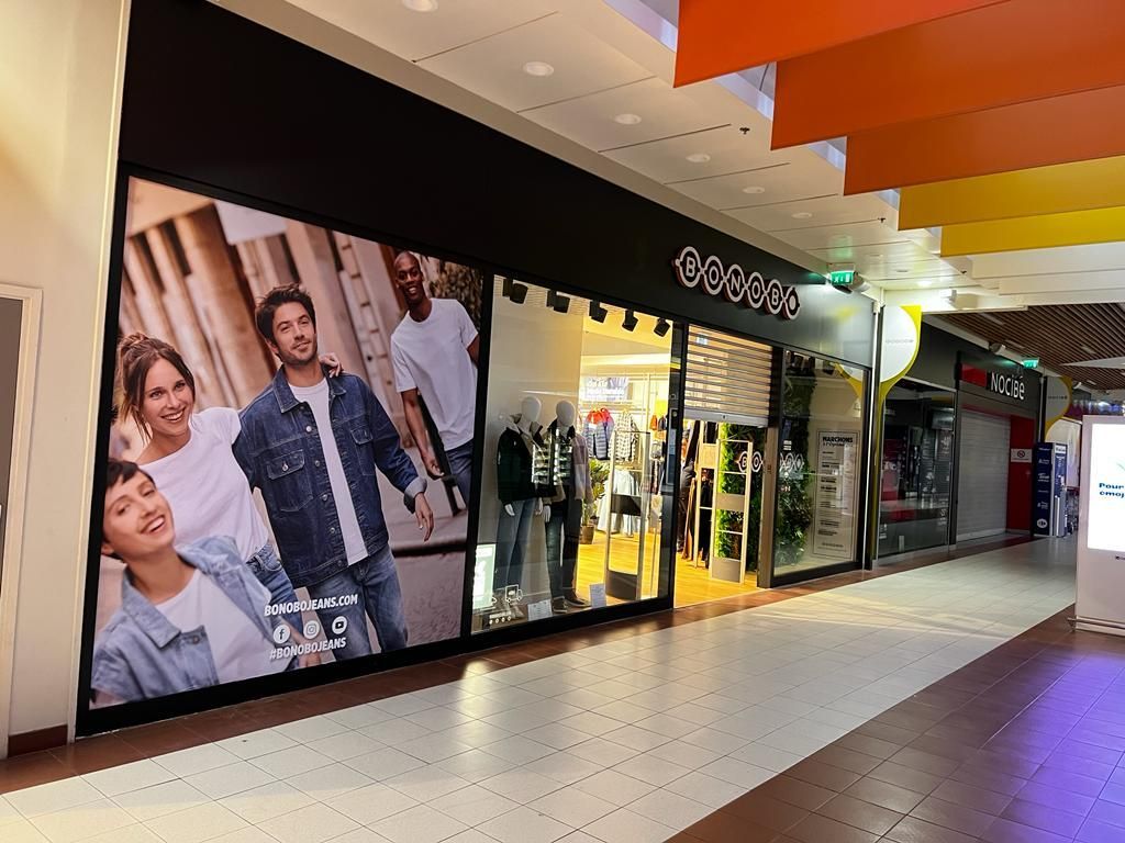 A store front with a large picture of a man and woman on it.