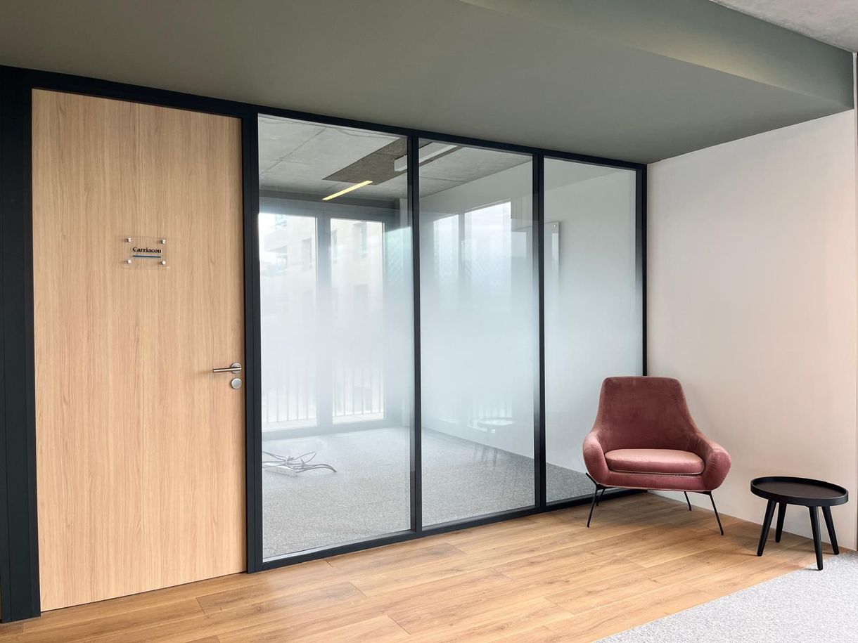 A room with a chair and a table in it.