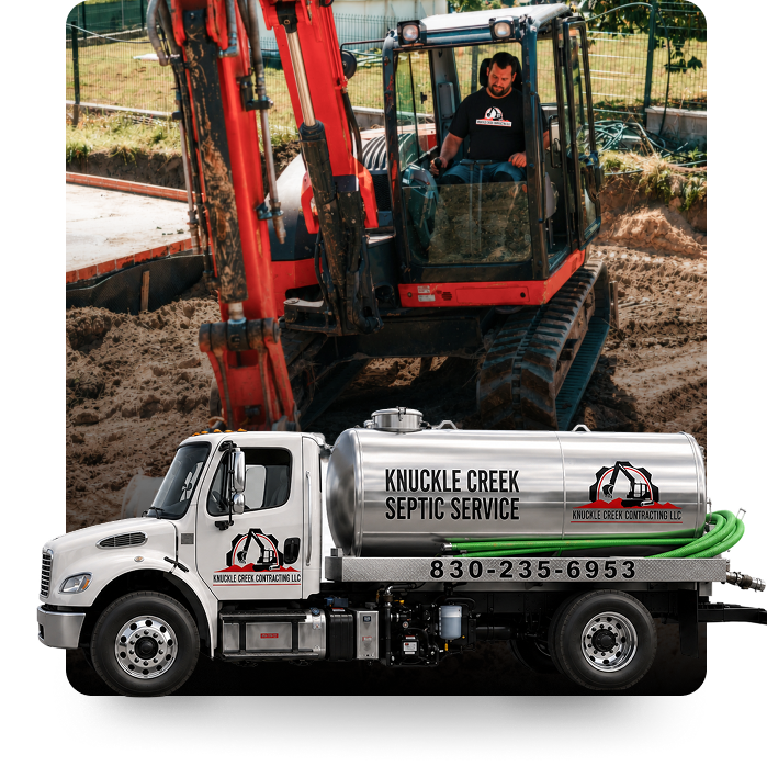 White septic service truck with logo in front of a red excavator at a worksite