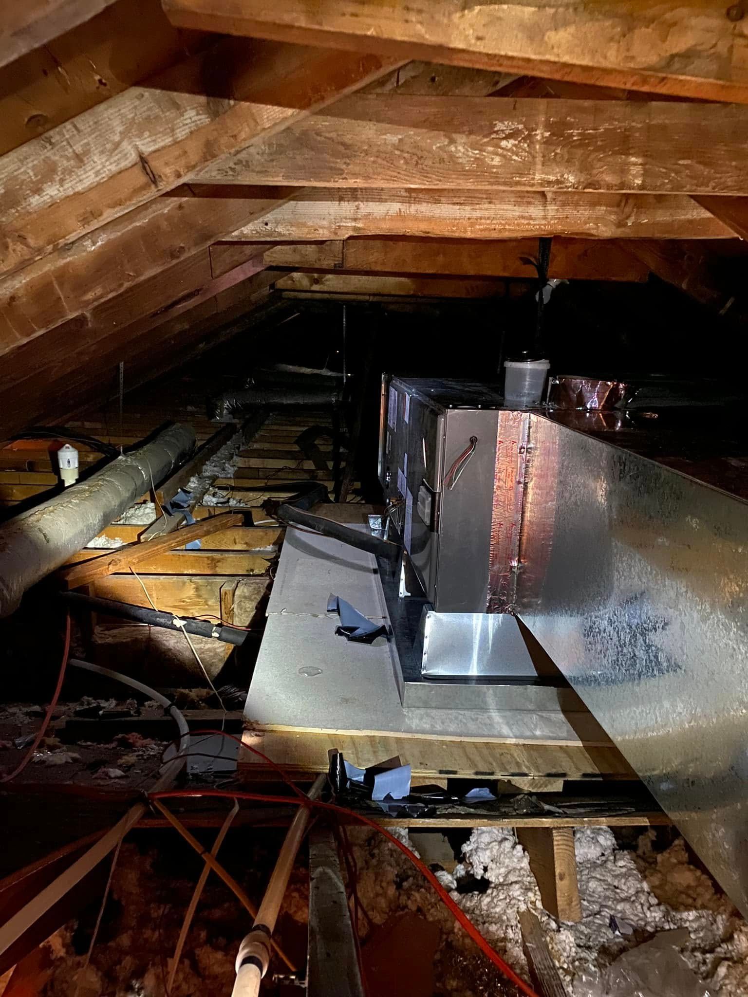 A picture of an attic with a ventilation system in it.