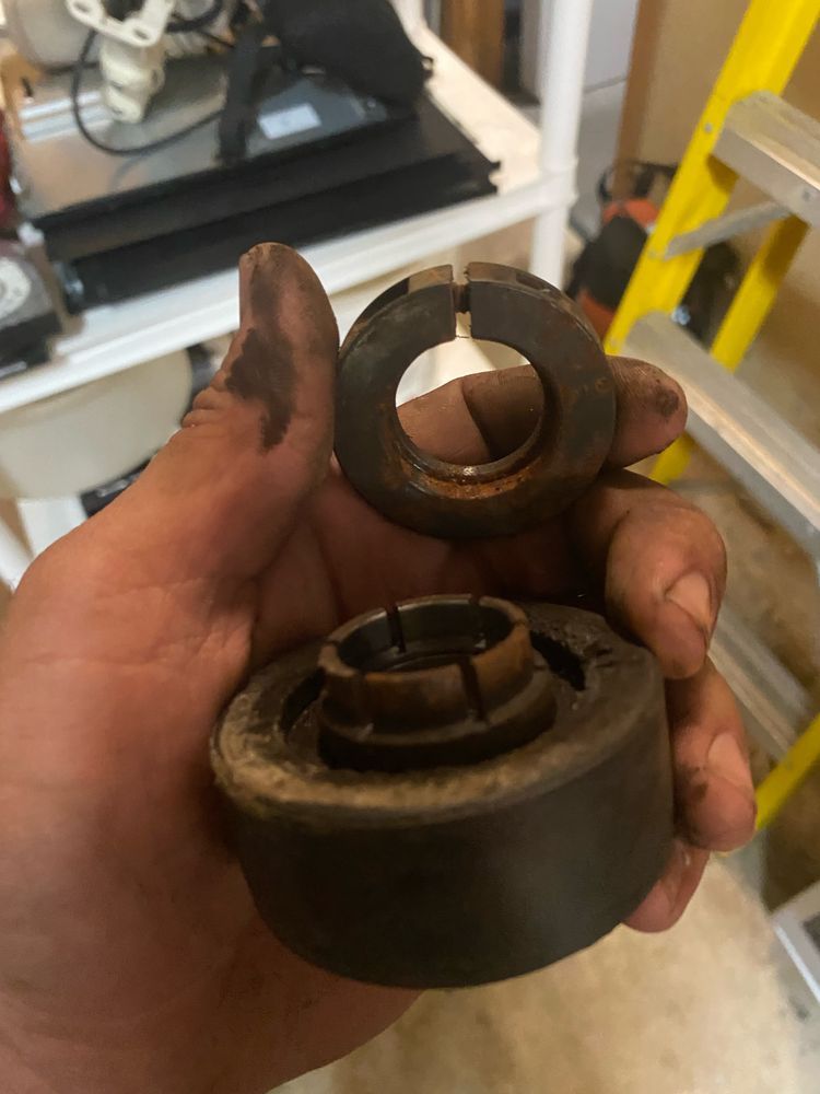 A person is holding two pieces of metal in their hand.