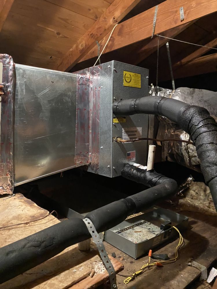 A ventilation system is being installed in the attic of a house.