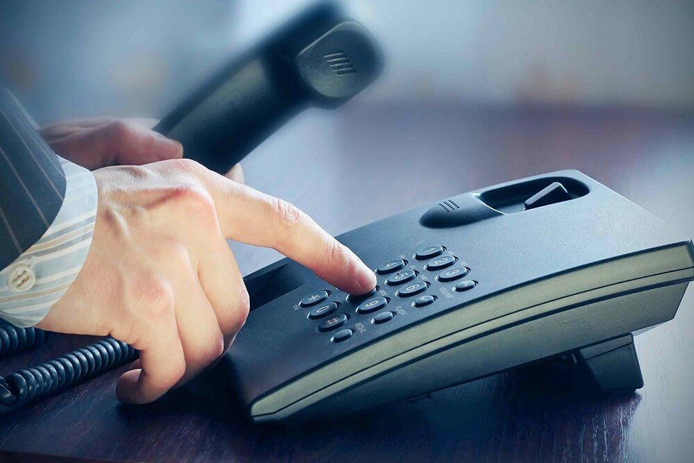 Man Dialing on Phone — Office Equipment in Hermit Park QLD