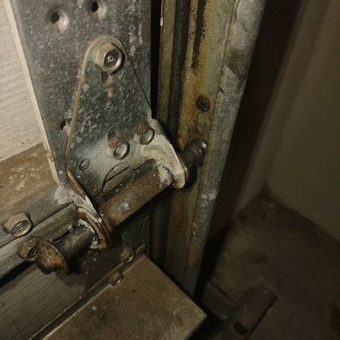 Broken garage door rollers replaced with new nylon rollers.