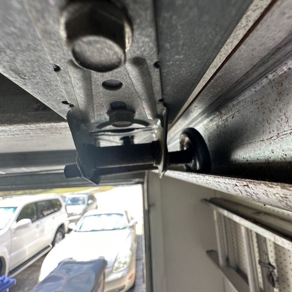 Broken garage door rollers replaced with new nylon rollers.