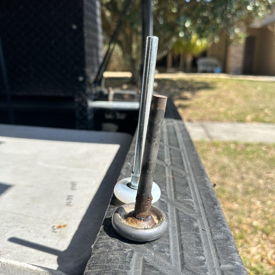 Broken garage door rollers replaced with new nylon rollers.