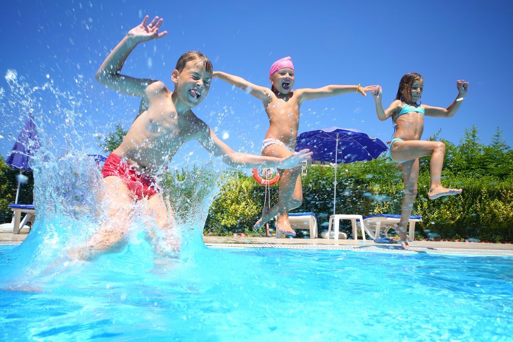 Group Of Children Jumping Into A Swimming Pool — Beaches Pool Supplies in Kewarra Beach, QLD