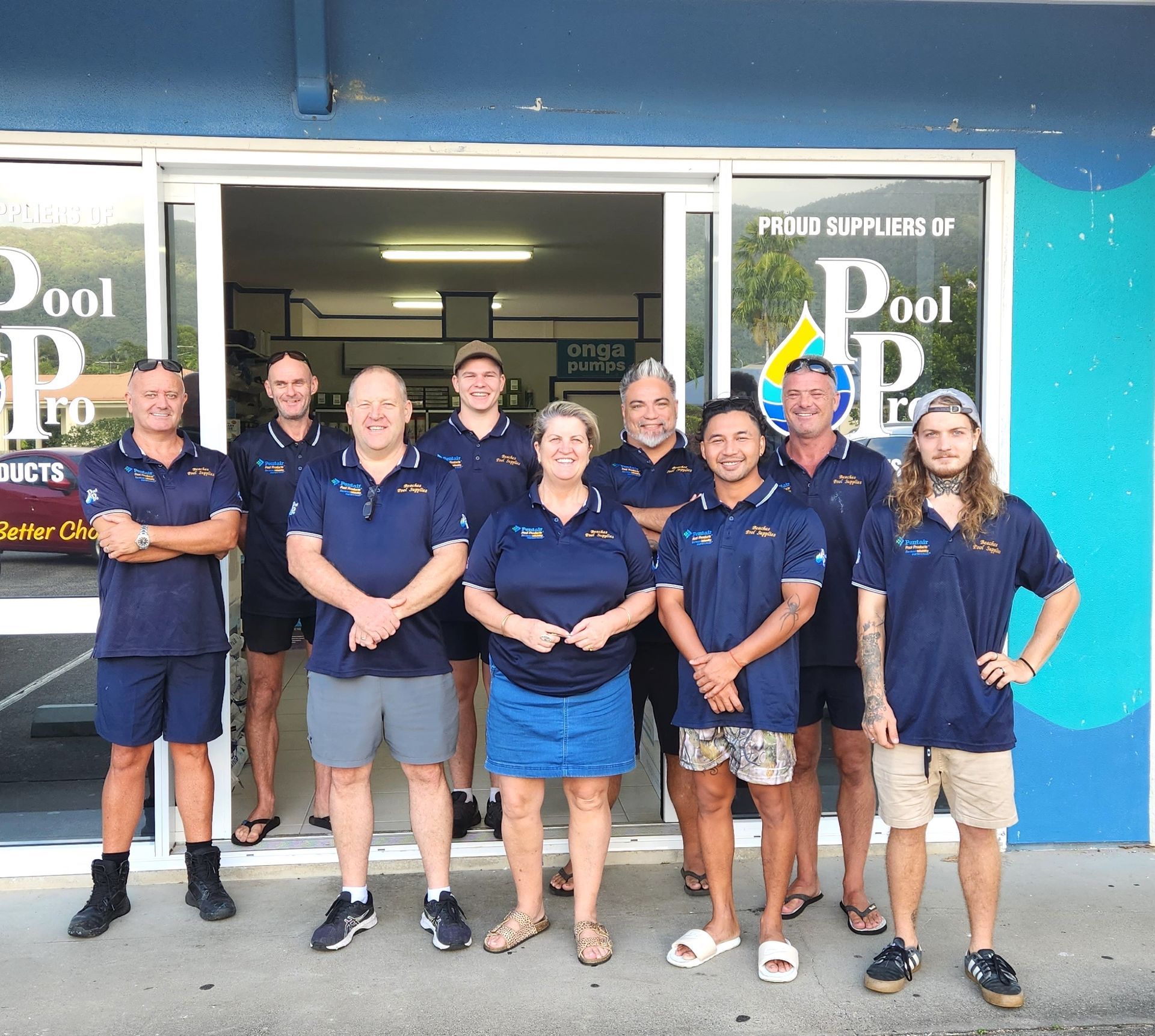 Group of people standing in front of a pool store — Pool Equipment Installation in Kewarra Beach QLD