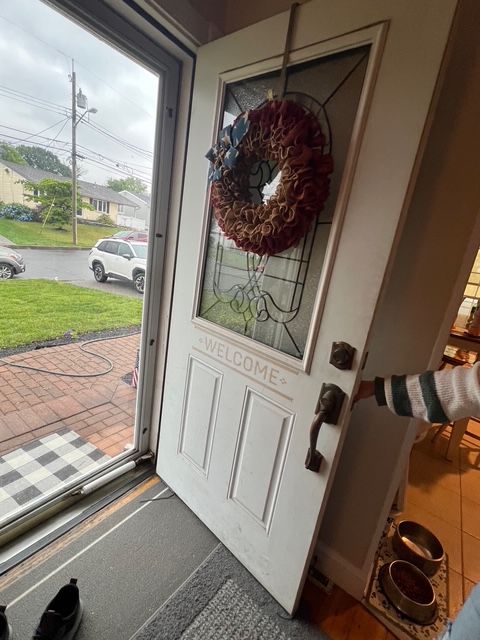 White door open, with wreath and 