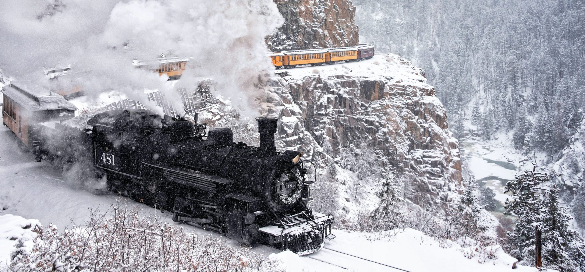 Steam train No. 49 in snowy mountains.