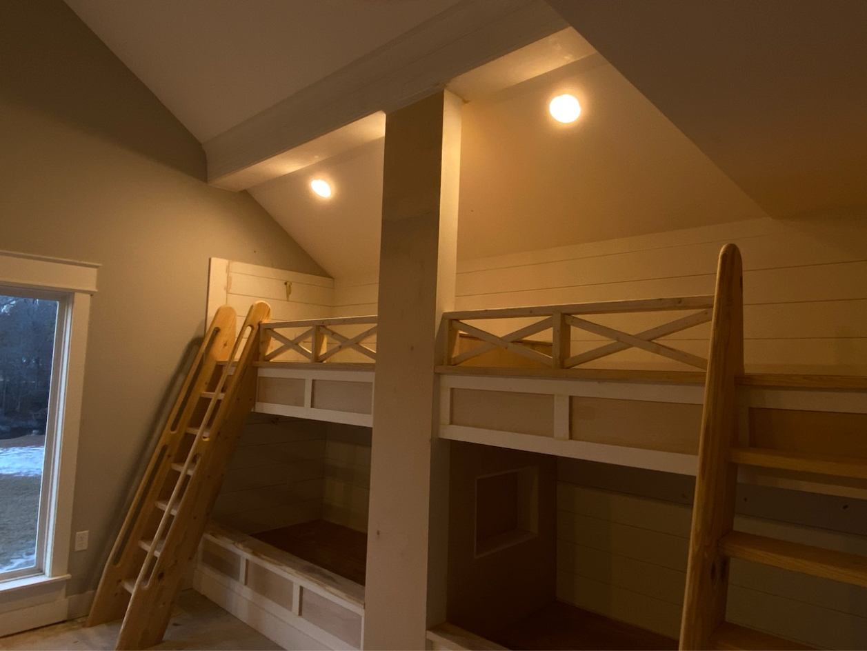 A room with bunk beds and a ladder in it