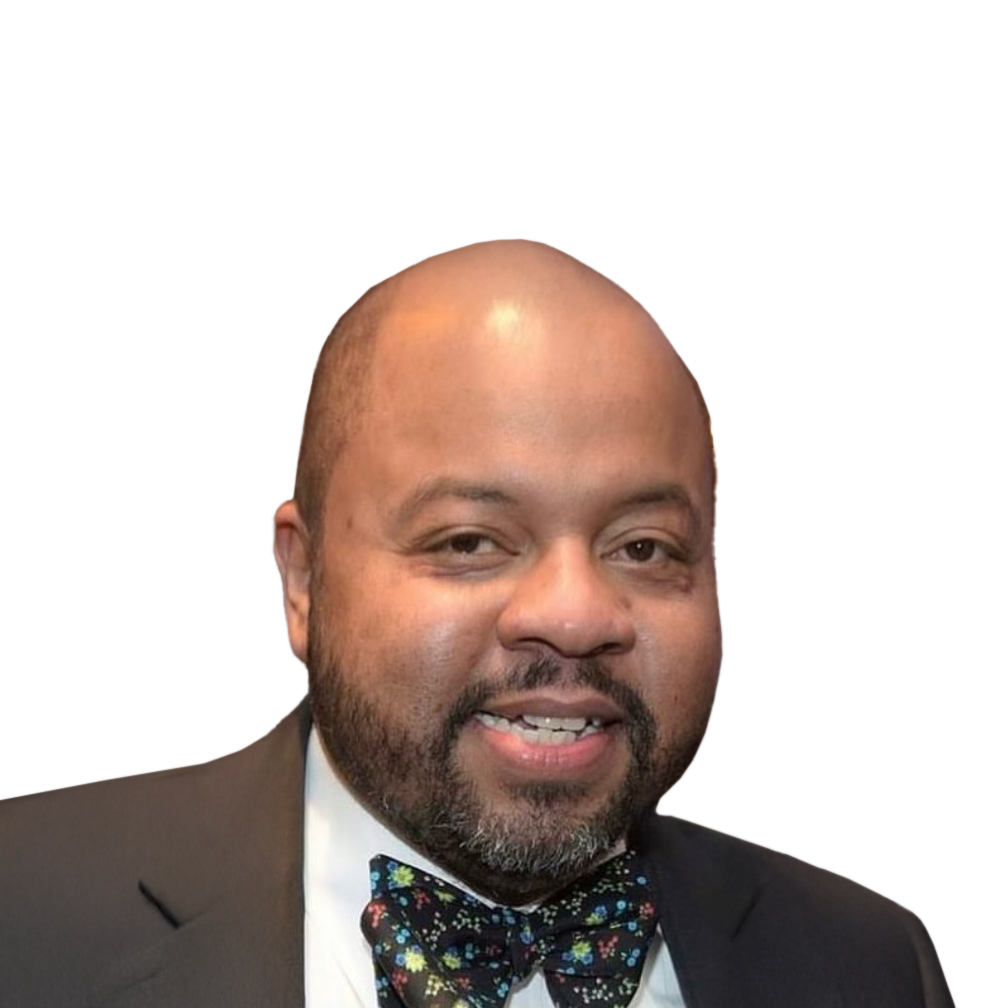 Man in a suit, bow tie, smiling, looking at the viewer.