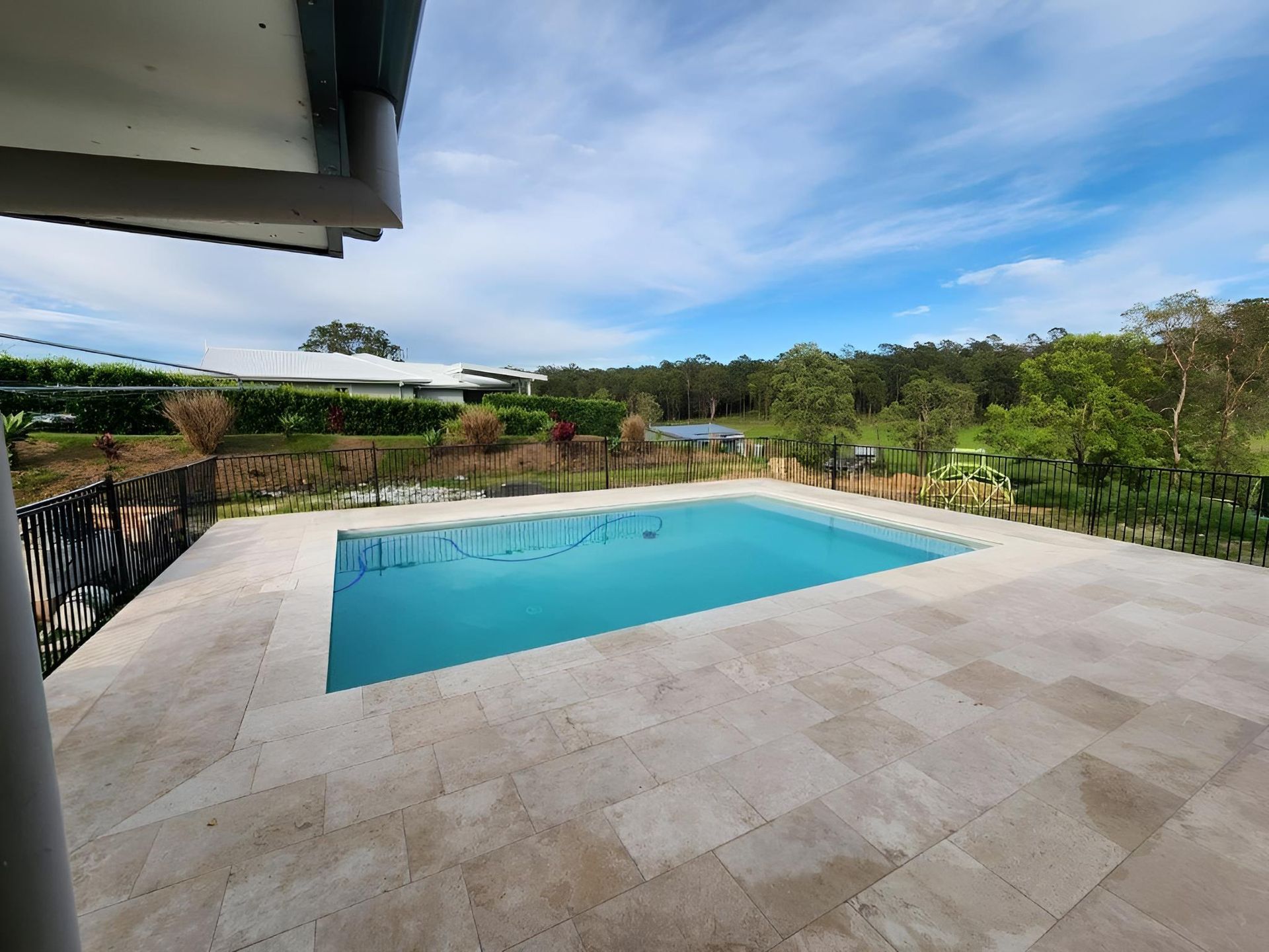 There Is A Large Swimming Pool In The Backyard Of A House — Ballina Pool Shop In Ballina, NSW