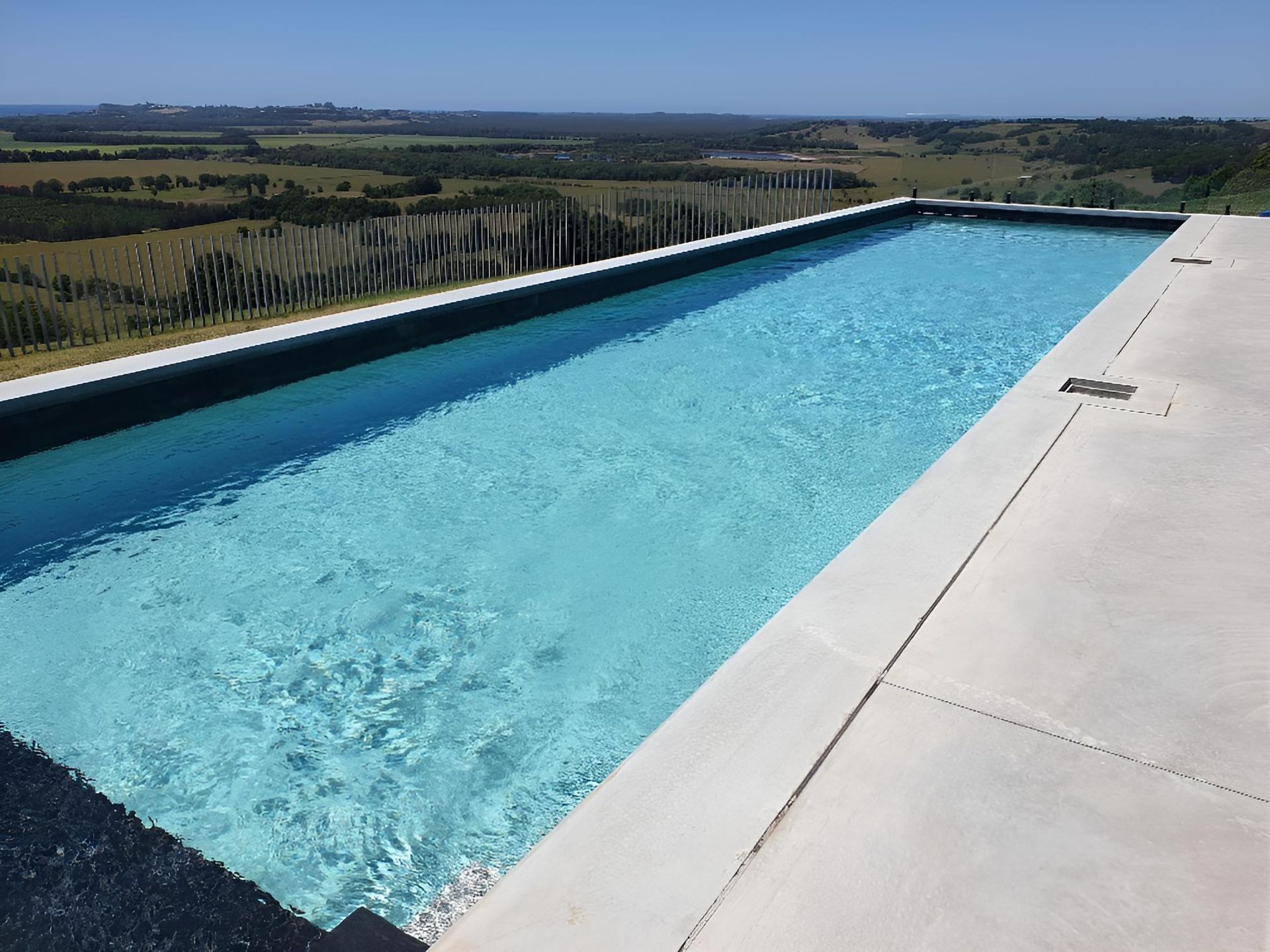 A Large Swimming Pool With A View Of The Countryside — Ballina Pool Shop In Ballina, NSW