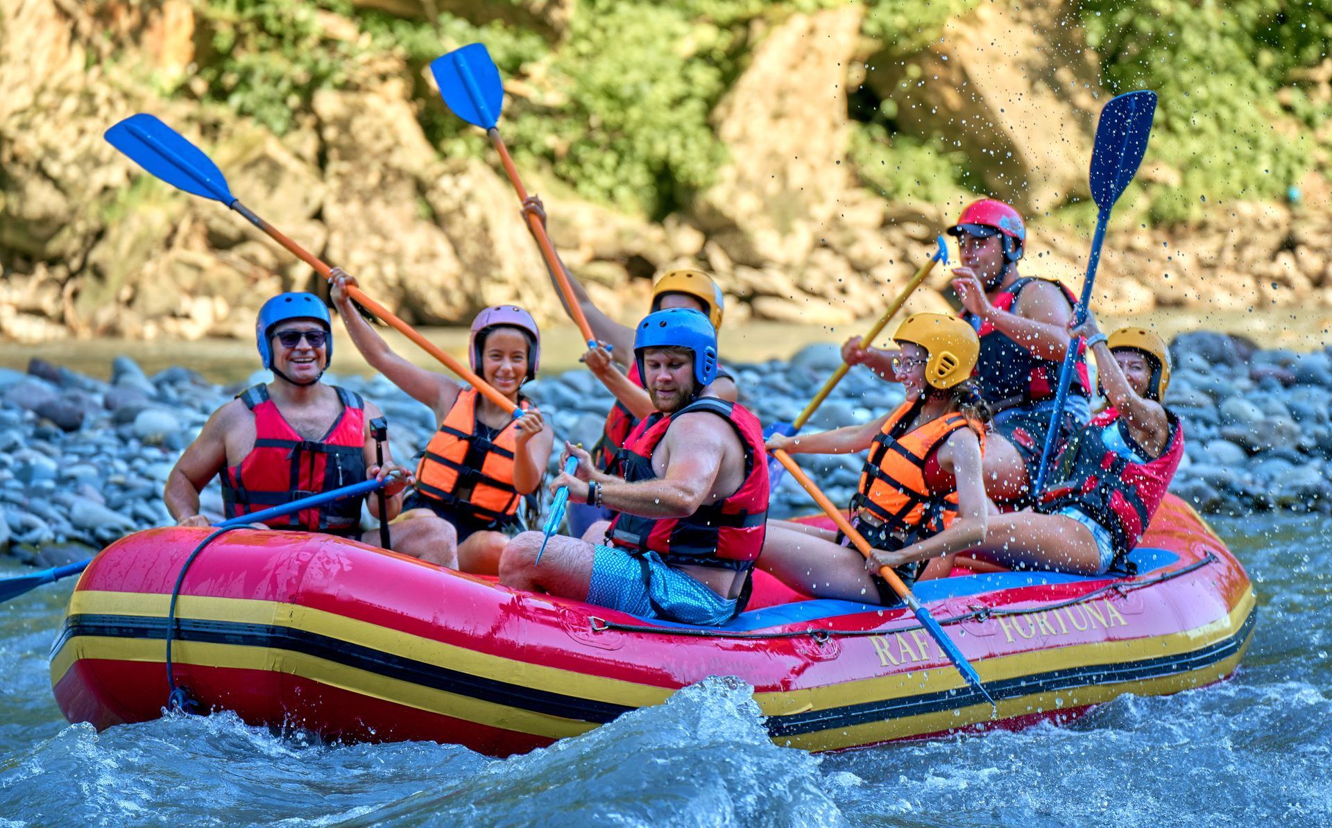 A group of people are rafting down a river in a raft.