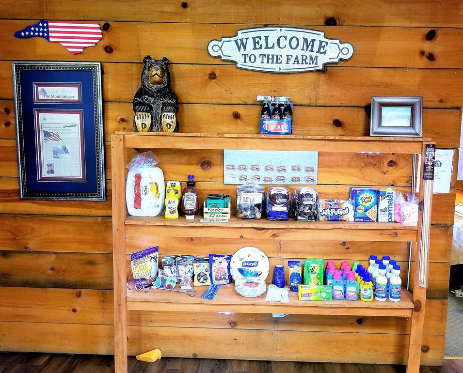 A welcome to the park sign hangs on a wooden wall