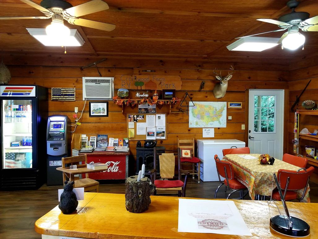 A room with a ceiling fan and a pepsi machine