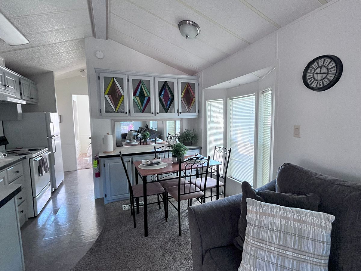 A living room with a couch and a clock on the wall