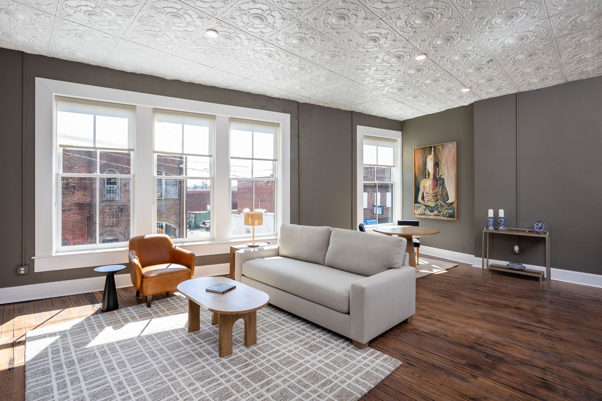 Living room with sofa, chair and dinning area.