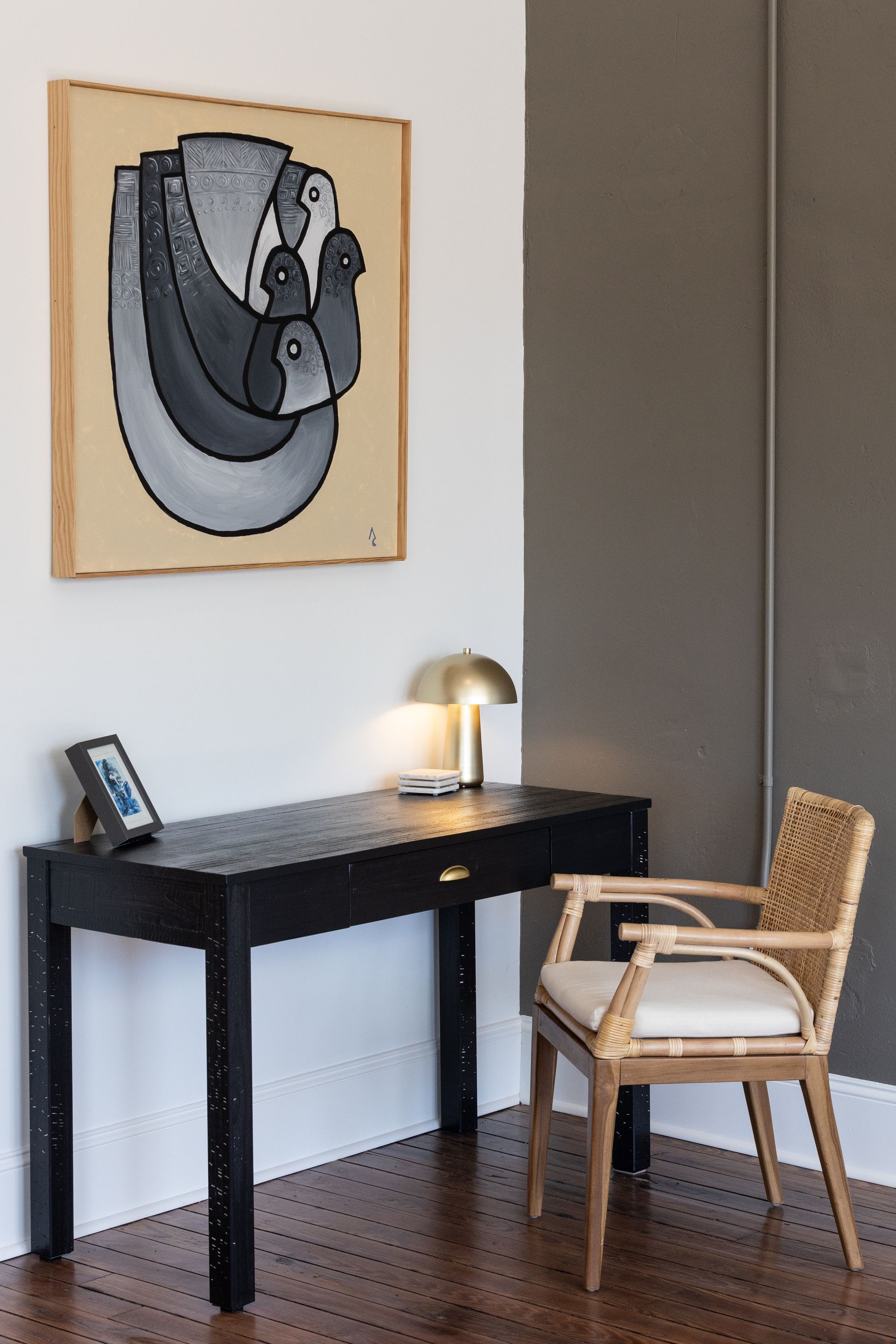 Art over a black desk.