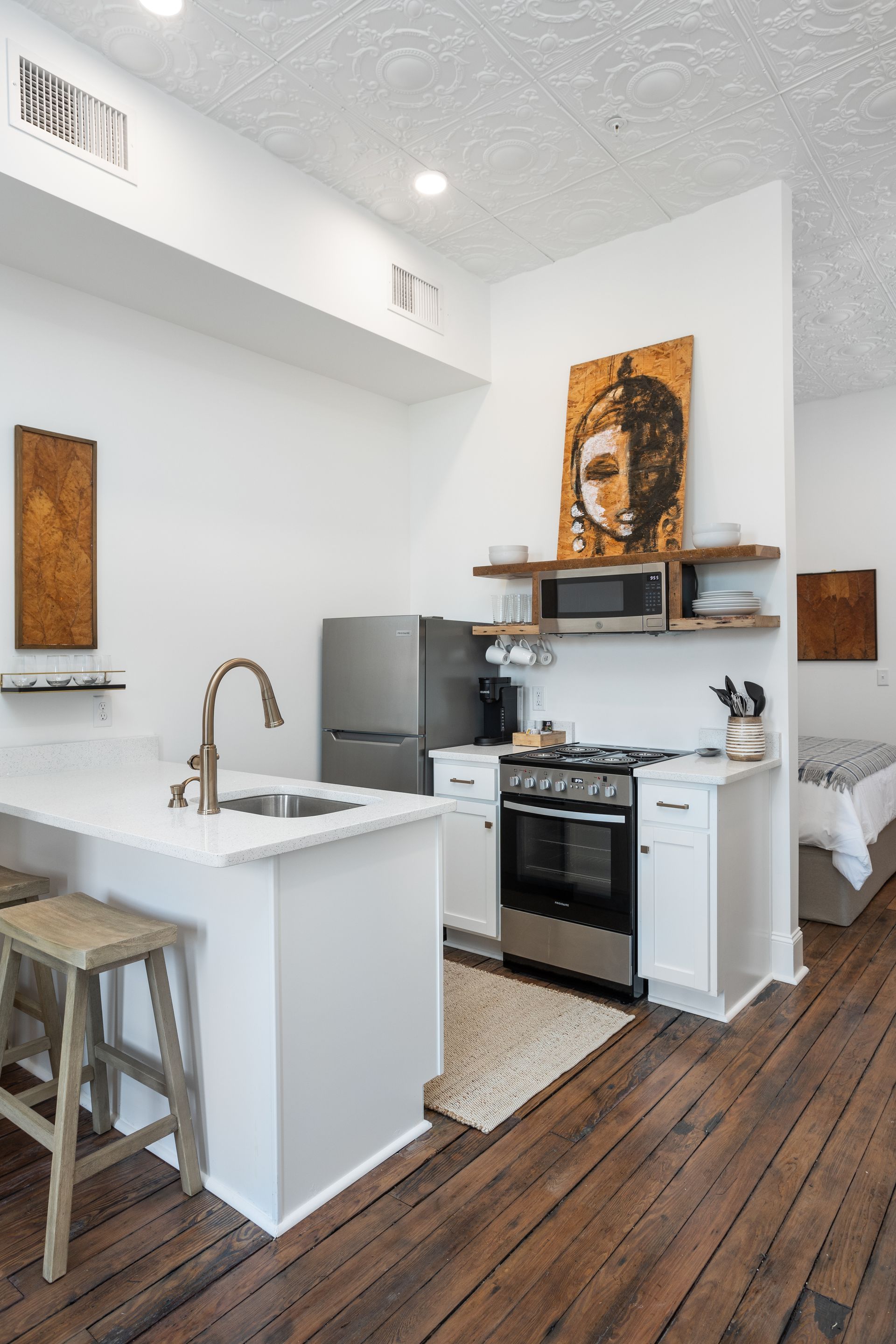 Galley kitchen with buddha art.