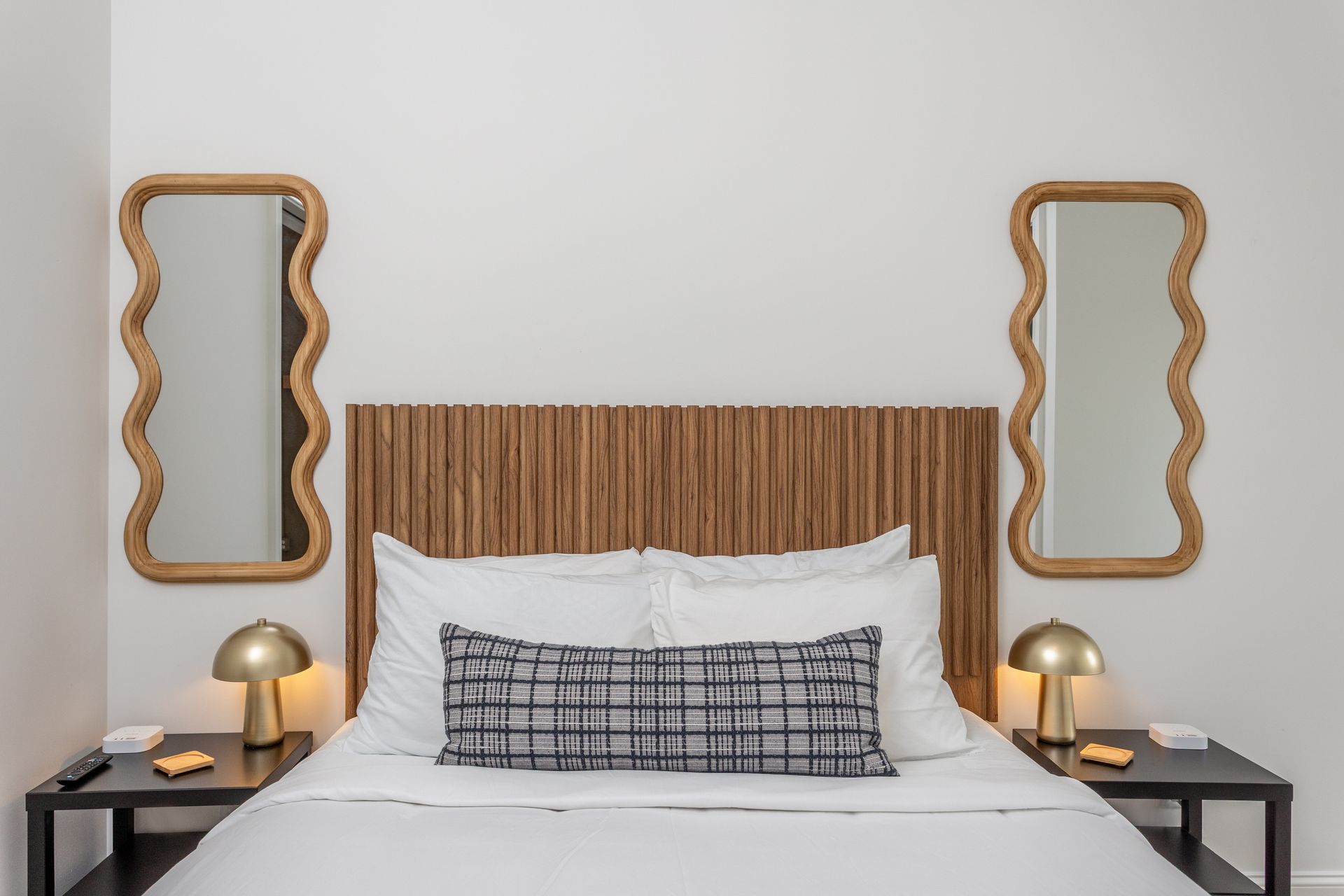 Bed with nightstands, and two mirrors