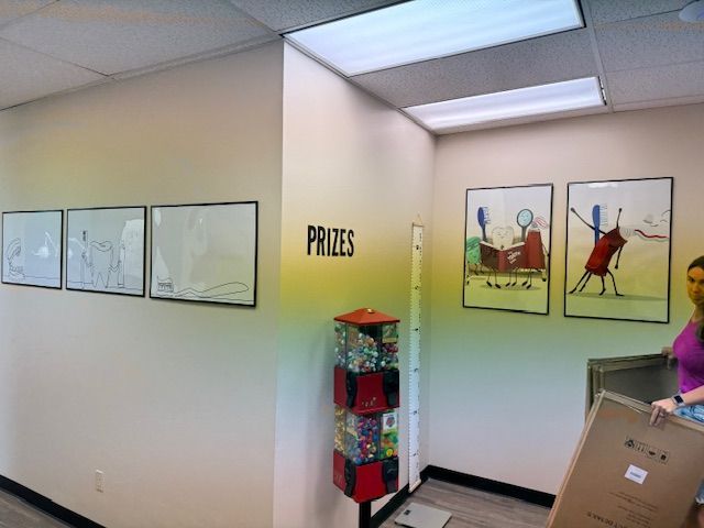 A woman is standing in front of a wall that says prizes