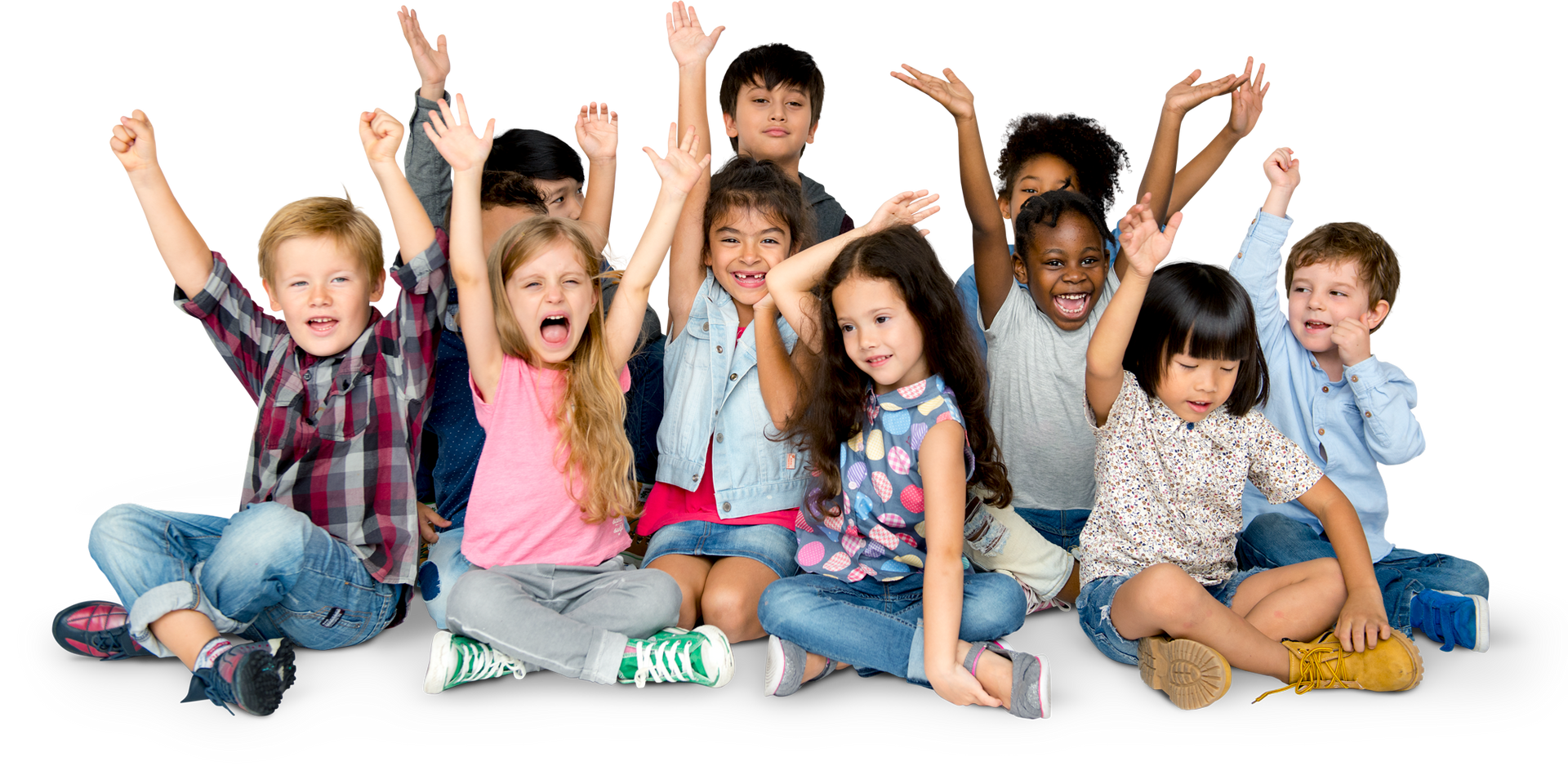 A group of children are sitting on the floor with their arms in the air.