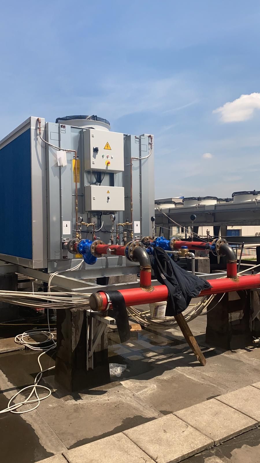 Un uomo è sdraiato a terra accanto a una grande macchina.