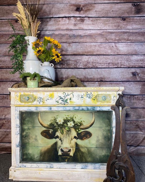 A wooden table with a picture of a cow on it.