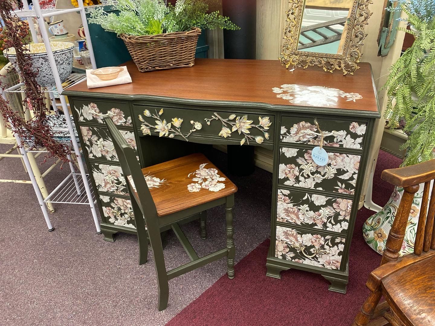 A desk with a chair and a mirror in a room.