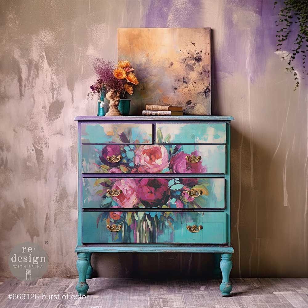 A blue dresser with a painting of flowers on it.