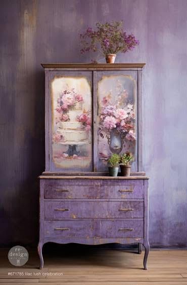 A purple dresser with a picture of a cake on it is in a room with a purple wall.