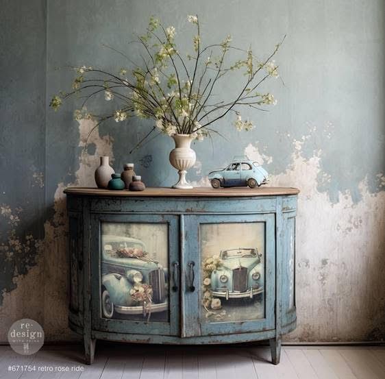 A blue cabinet with a vase of flowers on top of it