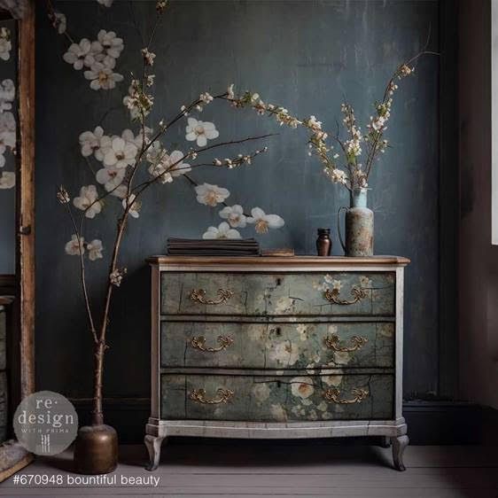 A dresser with flowers painted on it in a dark room