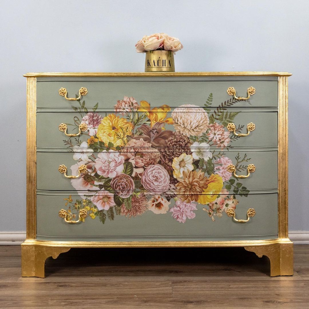 A dresser with a vase of flowers on top of it.