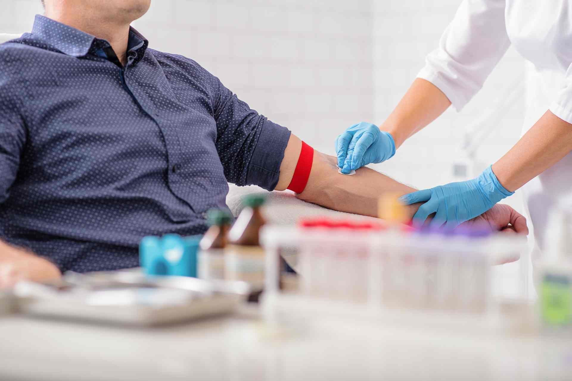 A medical practitioner preparing a patient for blood work samples near Harr