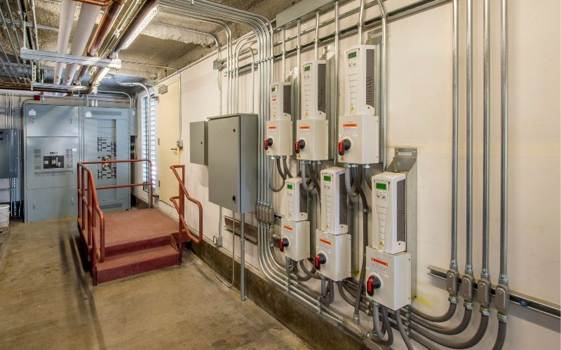 A room with a lot of electrical equipment on the wall.