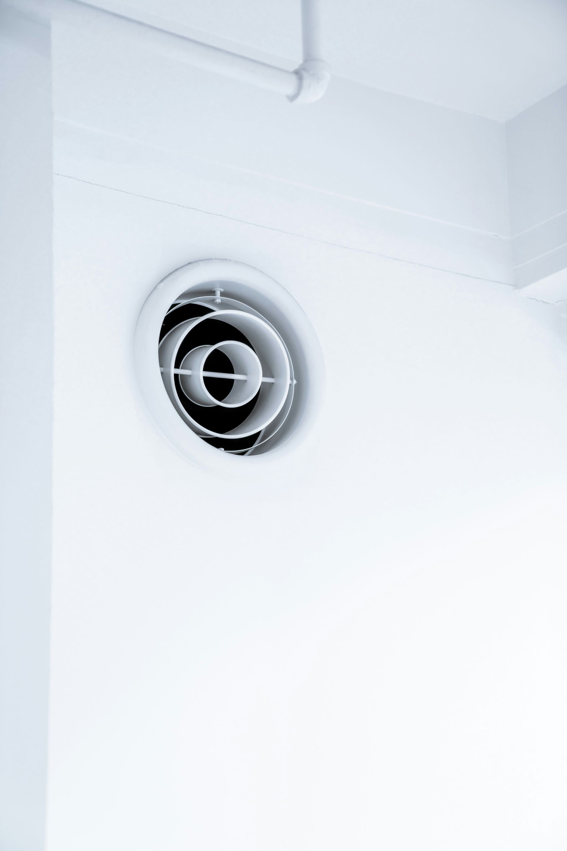 A close up of a white wall with a hole in it