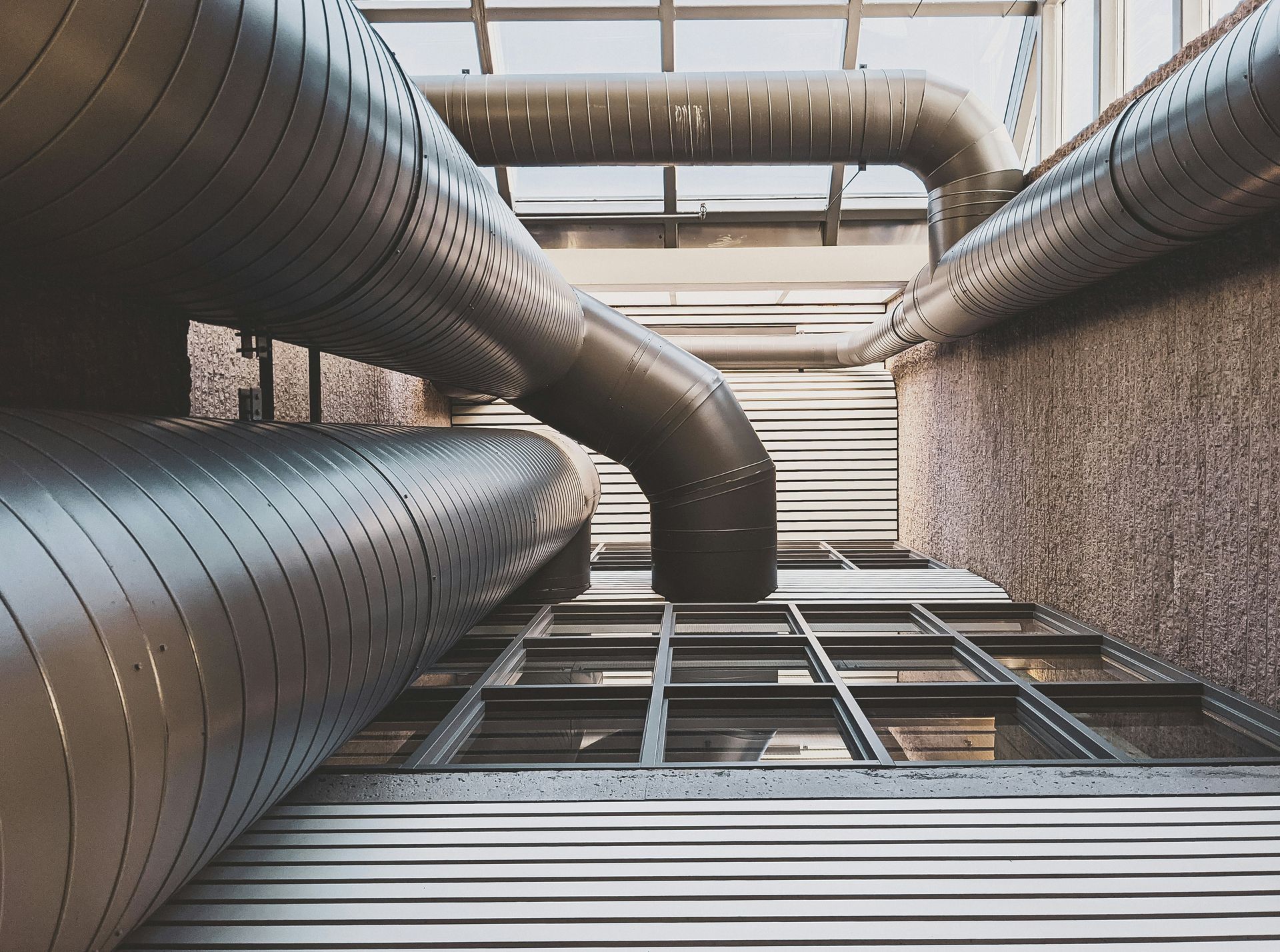 A bunch of pipes are connected to each other in a building.