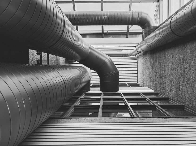 A black and white photo of pipes in a building