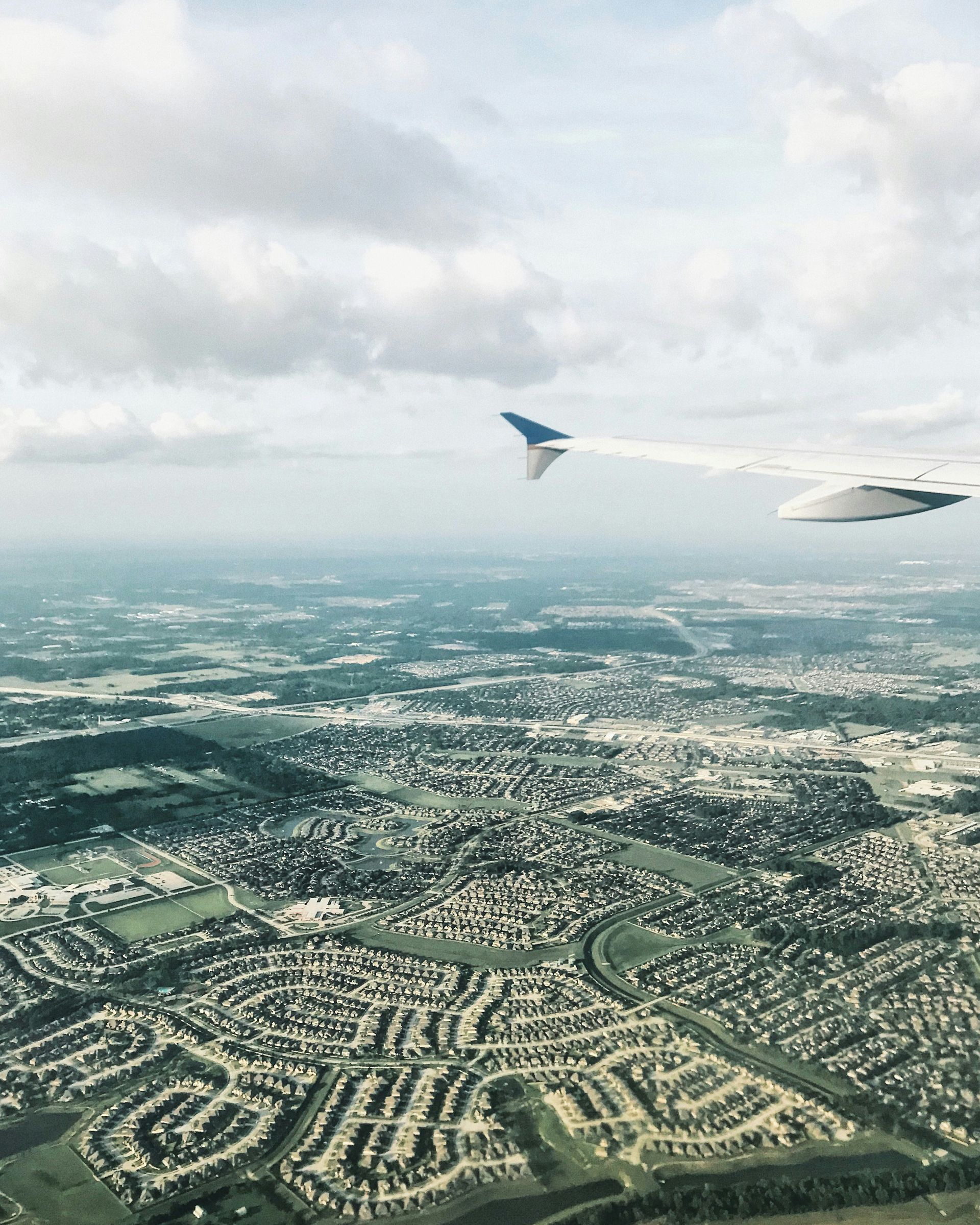 An aerial view of a city from an airplane window
