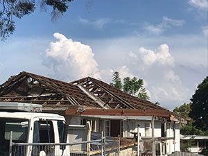 Two construction vehicles are parked next to each other on a dirt road.