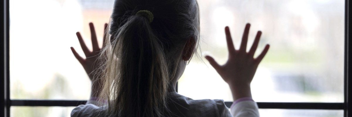 A child in front of a glass window
