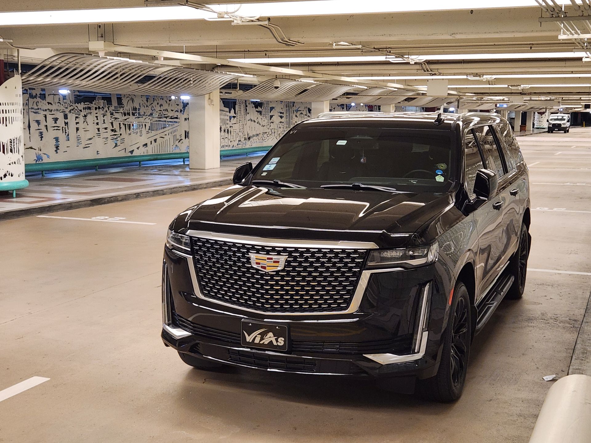 A black suv is parked in a parking garage.